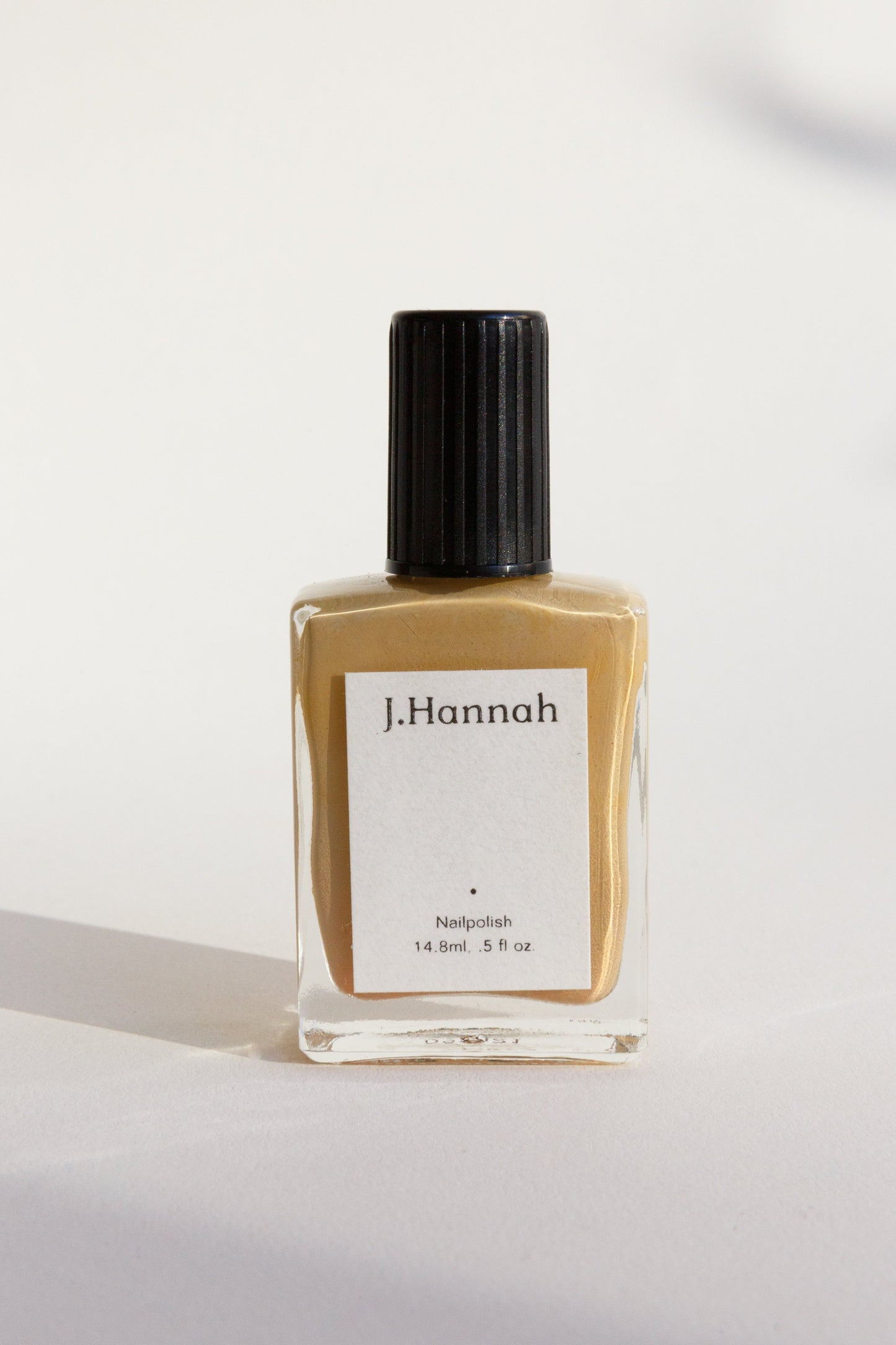 A bottle of yellow nail polish by J.Hannah